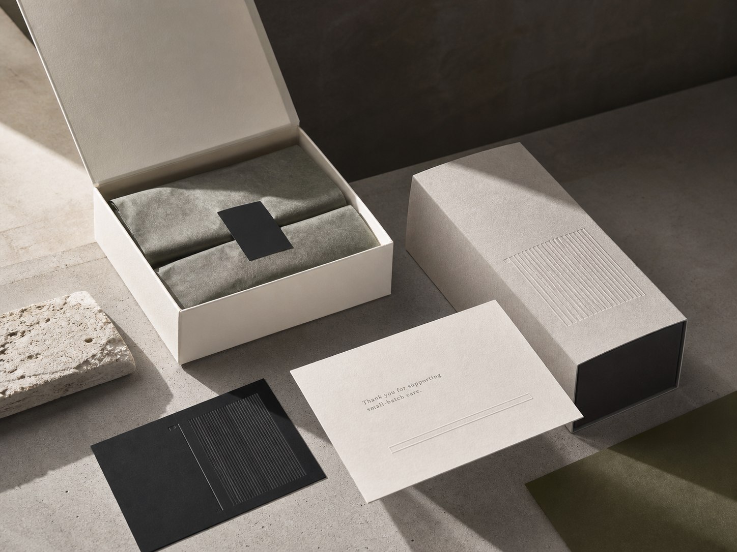 Minimal packaging concept using cream, charcoal and olive tones
