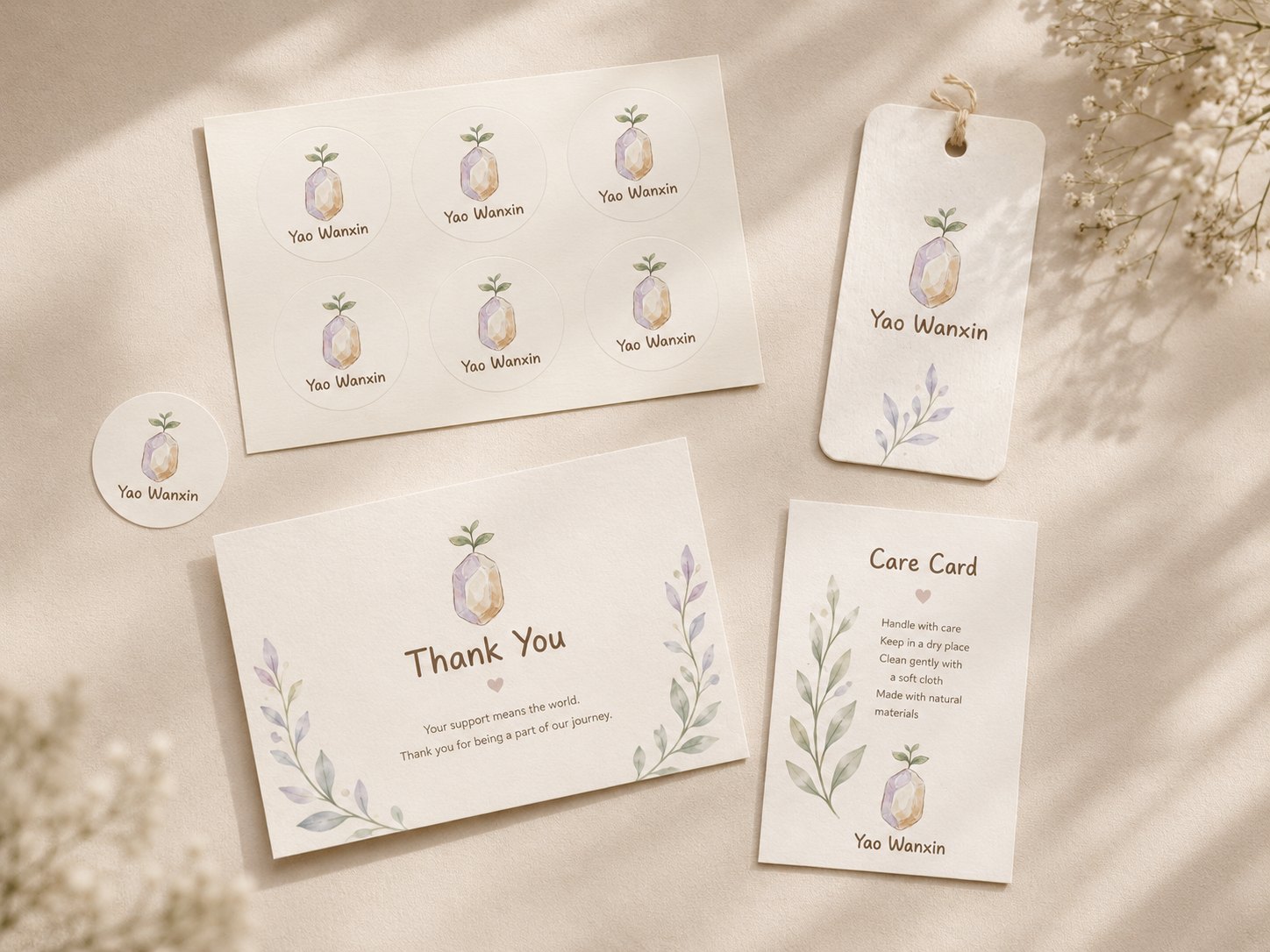 Concept arrangement showing printed cards, stickers and a hang tag